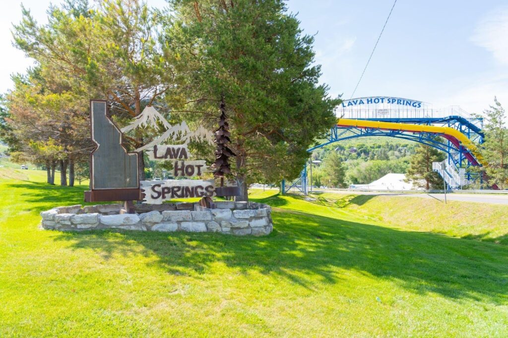 A sign for Lake Tahoe Resort is displayed in front of a vibrant green field indicating the resort location